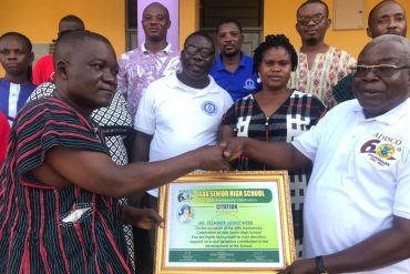 Dr Gabriel Ofoe Canacoo (right) chairman of Webb of Excellence Welfare Fund, receiving the special certificate of honour from Mr Kafui Kojo Ayibor, headmaster of the Ada Senior High School, on behalf of Ms Eleanor Louise Webb, Founder of the Webb of Excellence Welfare Fund.